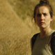 A woman carrying a backpack looks distressed in front of a grassy hill in a narrow horror stock footage.